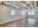 Unfinished basement space with wood laminate flooring and exposed ceiling at 2242 Greencrest Ne Dr, Atlanta, GA 30345
