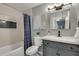 Well-lit bathroom featuring a shower-tub combo, a stylish vanity, and modern fixtures at 2242 Greencrest Ne Dr, Atlanta, GA 30345