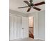 This bedroom features a closet, ceiling fan, and view into the hall at 2242 Greencrest Ne Dr, Atlanta, GA 30345