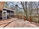 Spacious wooden deck with access to a screened porch and stairs leading to backyard space at 2242 Greencrest Ne Dr, Atlanta, GA 30345