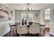 Bright dining room with dark wood table, stylish lighting, and large windows overlooking the backyard at 2242 Greencrest Ne Dr, Atlanta, GA 30345