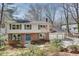 Two-story home with a brick facade, complemented by vinyl siding and a two-car garage at 2242 Greencrest Ne Dr, Atlanta, GA 30345