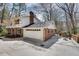 Close-up of two-car garage, with a spacious driveway and an outdoor seating area at 2242 Greencrest Ne Dr, Atlanta, GA 30345