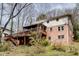 Backyard view showcases the brick home's deck, screened porch, and natural landscape at 2242 Greencrest Ne Dr, Atlanta, GA 30345