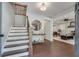 Inviting foyer with hardwood floors, staircase, and view into the living area at 2242 Greencrest Ne Dr, Atlanta, GA 30345