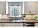 Bright kitchen with white cabinets, stainless steel appliances, and a view to the backyard at 2242 Greencrest Ne Dr, Atlanta, GA 30345