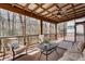 Relaxing screened porch featuring a ceiling fan and comfortable seating with a view of the private, wooded surroundings at 2242 Greencrest Ne Dr, Atlanta, GA 30345