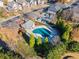 Aerial view of a community pool surrounded by lush trees, a gazebo and convenient parking at 2591 Royston Dr, Duluth, GA 30097
