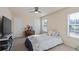 Cozy bedroom with neutral tones, a ceiling fan, and natural light from a window at 2591 Royston Dr, Duluth, GA 30097