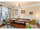 Inviting dining room featuring a wooden table, bench, stylish chairs, and a bright window at 2591 Royston Dr, Duluth, GA 30097