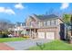 Lovely brick home with a two-car garage, front porch, and a beautifully landscaped lawn at 2591 Royston Dr, Duluth, GA 30097