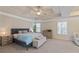 Bright main bedroom with tray ceiling, carpet flooring and natural light at 2591 Royston Dr, Duluth, GA 30097