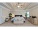 Spacious main bedroom with a tray ceiling, fan, and neutral tones at 2591 Royston Dr, Duluth, GA 30097