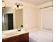 Bathroom with a double vanity, large mirror, soaking tub, and modern light fixtures at 3356 Sardis Bend Dr, Buford, GA 30519