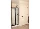 Bathroom with a standing shower with dark metal accents and a closed white door at 3356 Sardis Bend Dr, Buford, GA 30519