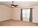 Relax in this bedroom with plush carpets, neutral paint, a ceiling fan, and large window for natural light at 3356 Sardis Bend Dr, Buford, GA 30519