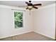 Bedroom with neutral walls, plush carpet, a window, and a ceiling fan with light at 3356 Sardis Bend Dr, Buford, GA 30519