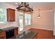 Cozy dining area featuring tile backsplash, access to backyard, and stylish lighting at 3356 Sardis Bend Dr, Buford, GA 30519