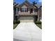 Traditional townhome with neutral siding, red shutters, a two-car garage, and a concrete driveway at 3356 Sardis Bend Dr, Buford, GA 30519