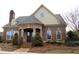 Charming brick home with manicured landscaping and a stone arched porch at 3356 Sardis Bend Dr, Buford, GA 30519
