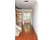 Spacious hallway with hardwood floors, white trim, stairs, and natural light from large window at 3356 Sardis Bend Dr, Buford, GA 30519