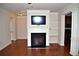Bright living room with hardwood floors, white trim and fireplace with large flat screen television at 3356 Sardis Bend Dr, Buford, GA 30519