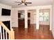Bright living room featuring hardwood floors, decorative columns, and a fireplace at 3356 Sardis Bend Dr, Buford, GA 30519