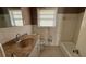 Well-lit bathroom featuring a single sink vanity and combined tub and shower, perfect for everyday use at 781 E Glochester Pl, Norcross, GA 30071