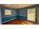 Bright blue bedroom with natural light, hardwood floors, and a serene atmosphere for peaceful sleep at 781 E Glochester Pl, Norcross, GA 30071