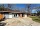 Single-story brick home with a spacious driveway and a mix of brick and siding at 781 E Glochester Pl, Norcross, GA 30071