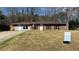 Charming single-story brick home with a well-maintained lawn and mature trees at 781 E Glochester Pl, Norcross, GA 30071