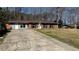 Attractive single-story home featuring a brick facade, a wide driveway, and a nicely sized front yard at 781 E Glochester Pl, Norcross, GA 30071