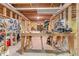 Unfinished basement workshop featuring a table, tools, and exposed beams at 1463 Bailey Farm Sw Dr, Marietta, GA 30064