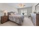Comfortable bedroom showcasing a ceiling fan, bright windows, and complementary furniture at 1463 Bailey Farm Sw Dr, Marietta, GA 30064