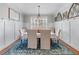 Bright dining room with white wainscoting, a large rug, and decorative arched accents at 1463 Bailey Farm Sw Dr, Marietta, GA 30064