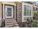 Charming entryway featuring stone steps, a decorative door, and a bright window with beautiful trim at 1463 Bailey Farm Sw Dr, Marietta, GA 30064