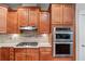 Close up of a modern kitchen with stainless steel appliances and wooden cabinets at 1463 Bailey Farm Sw Dr, Marietta, GA 30064