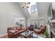 Inviting living room with a vaulted ceiling, a stone fireplace, and hardwood floors with comfortable furniture at 1463 Bailey Farm Sw Dr, Marietta, GA 30064