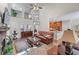 Open-concept living room with high ceilings, hardwood floors, a stone fireplace, and views of the kitchen at 1463 Bailey Farm Sw Dr, Marietta, GA 30064