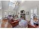 Spacious living room with a stone fireplace, hardwood floors, and ample natural light from large windows at 1463 Bailey Farm Sw Dr, Marietta, GA 30064