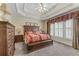 Well-lit main bedroom with tray ceilings, large windows, and elegant furnishings at 1463 Bailey Farm Sw Dr, Marietta, GA 30064