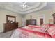Comfortable main bedroom featuring a tray ceiling, large dresser, and ample closet space at 1463 Bailey Farm Sw Dr, Marietta, GA 30064