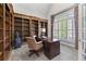 Cozy home office with built-in bookshelves, a classic desk, and natural light from the window at 1463 Bailey Farm Sw Dr, Marietta, GA 30064