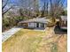 Aerial view showcases a charming house, driveway, and manicured front lawn at 2047 Boulderview Se Dr, Atlanta, GA 30316