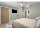 Bright bedroom featuring light green walls, ceiling fan, and adjacent doors at 2047 Boulderview Se Dr, Atlanta, GA 30316