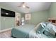 Comfortable bedroom featuring an en-suite bathroom and a view of the mounted TV at 2047 Boulderview Se Dr, Atlanta, GA 30316