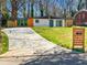 Charming renovated ranch-style home featuring a new driveway, fresh landscaping, and a modern exterior design at 2047 Boulderview Se Dr, Atlanta, GA 30316