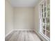 Cozy bedroom with neutral paint, wood floors, and a large window overlooking nature at 3355 Lauada Dr, Douglasville, GA 30135