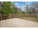 Wooden deck with a wooden railing and green trees surrounding at 3355 Lauada Dr, Douglasville, GA 30135