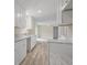 Well-lit kitchen with white cabinets, granite countertops, and wood floors at 3355 Lauada Dr, Douglasville, GA 30135